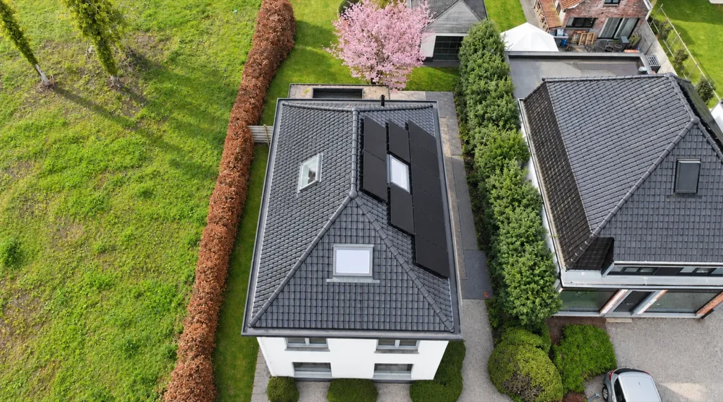 Dakrenovatie De Pinte: het dak met dakramen en zonnepanelen recht van boven